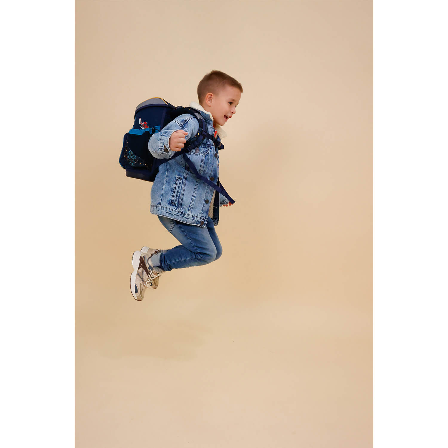 Side view of the Belmil Mini-Fit Ergonomic School Bag Set for Boys “Tractron” Design + Dinosaur Raincoat – 5-Piece Compact and Back-Friendly School Starter Set showing adjustable straps.