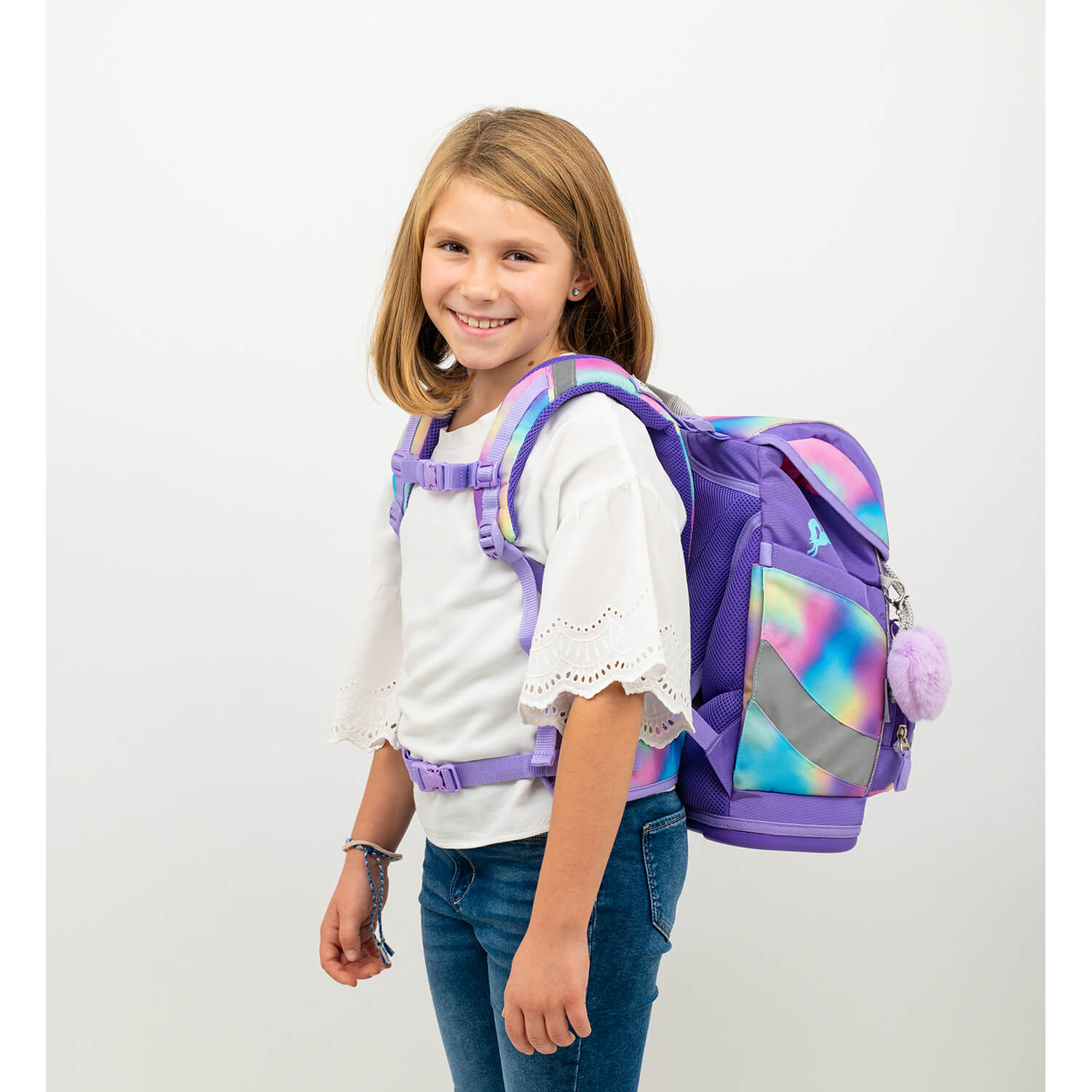 A happy child wearing the Belmil Smarty Rainbow Color Ergonomic School Bag Set – 5-Piece Set with 9 Interchangeable Patches and Hip Belt, highlighting a comfortable ergonomic fit from the vendor sale.
