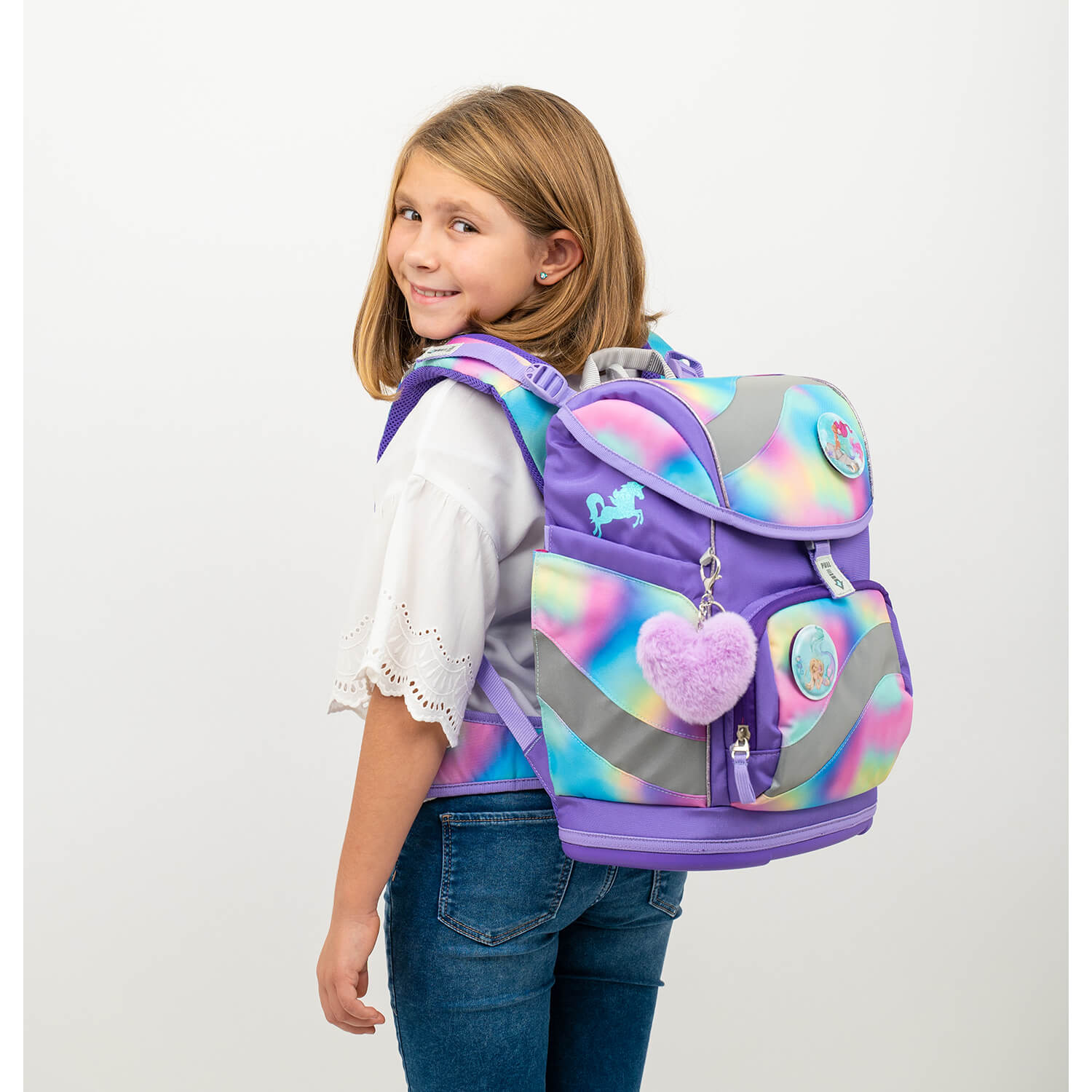 Side view of a child with the Belmil Smarty Rainbow Color Ergonomic School Bag Set – 5-Piece Set with 9 Interchangeable Patches and Hip Belt, featuring bright colors and fun designs by the vendor sale.