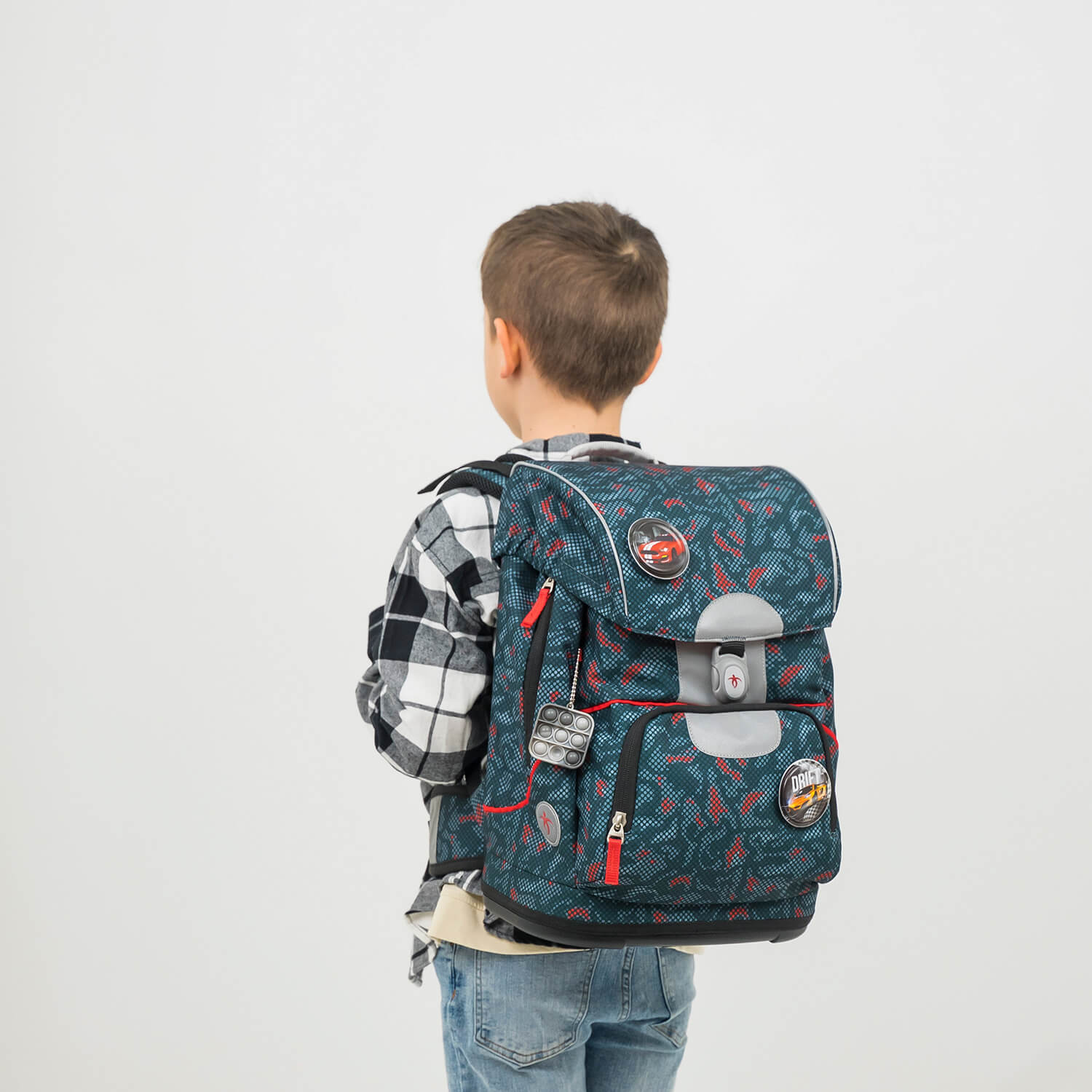 The Belmil Motion School Bag set includes 9 interchangeable decorative patches for personalization, shown on the bag.